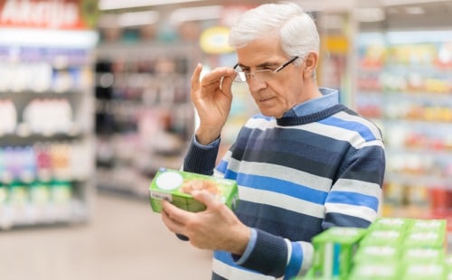 Man looking at nutrition facts label