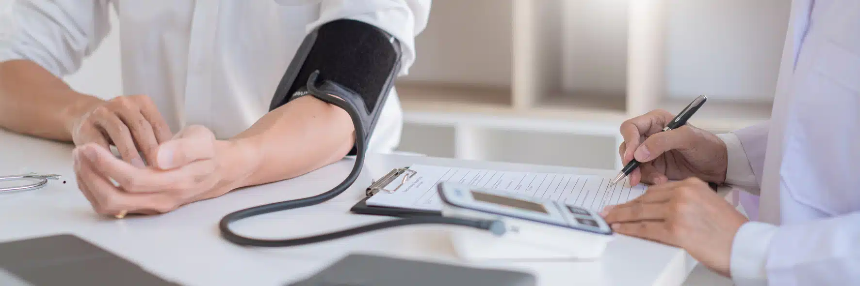 Doctor using sphygmomanometer or tonometer measuring blood pressure to a patient examined the heartbeat and talked about health care in the hospital Blood Pressure Test