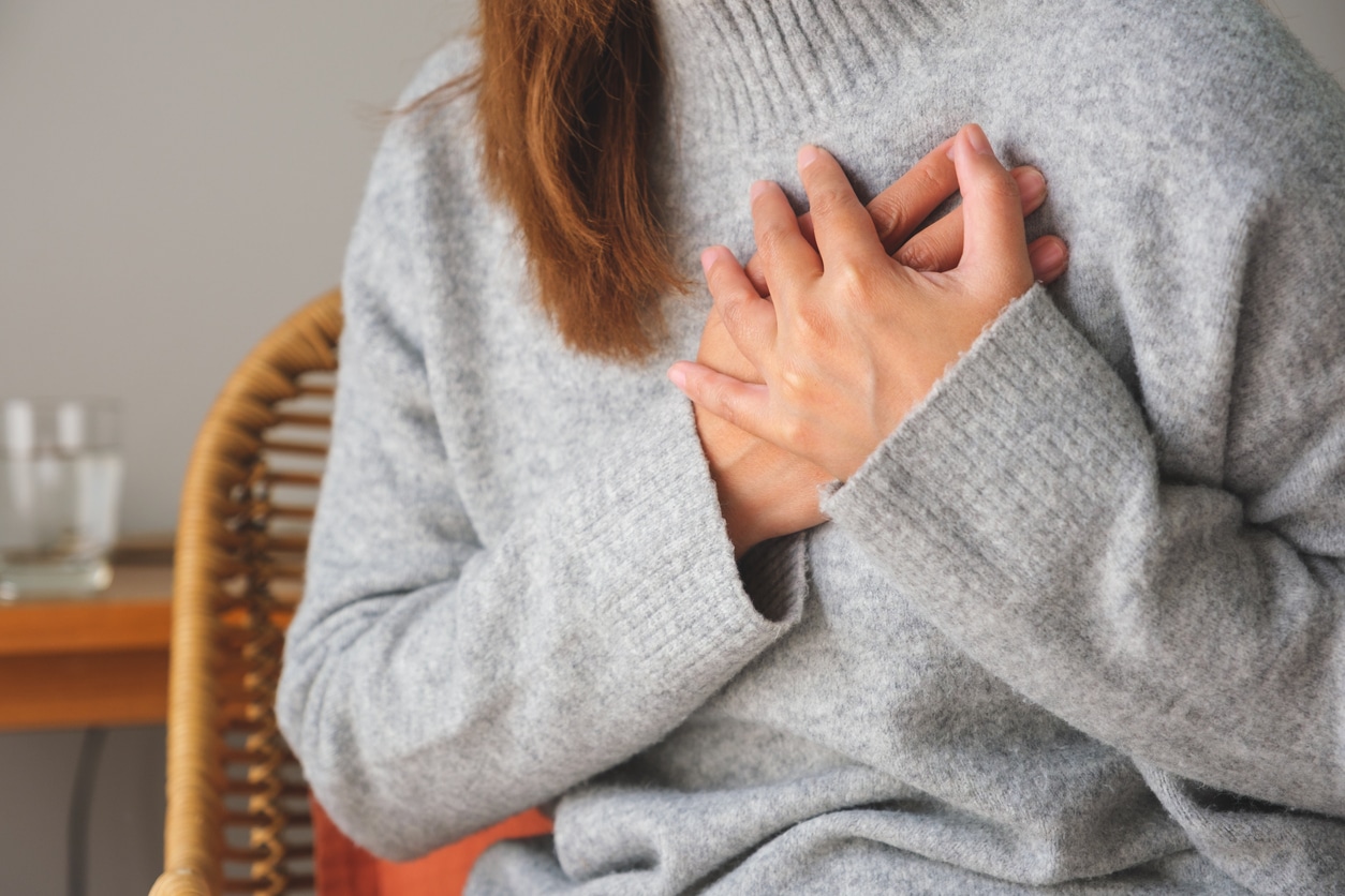 Closeup image of a woman with hands on chest, sudden heart attack, suffering from chest pain Heart Disease In Women