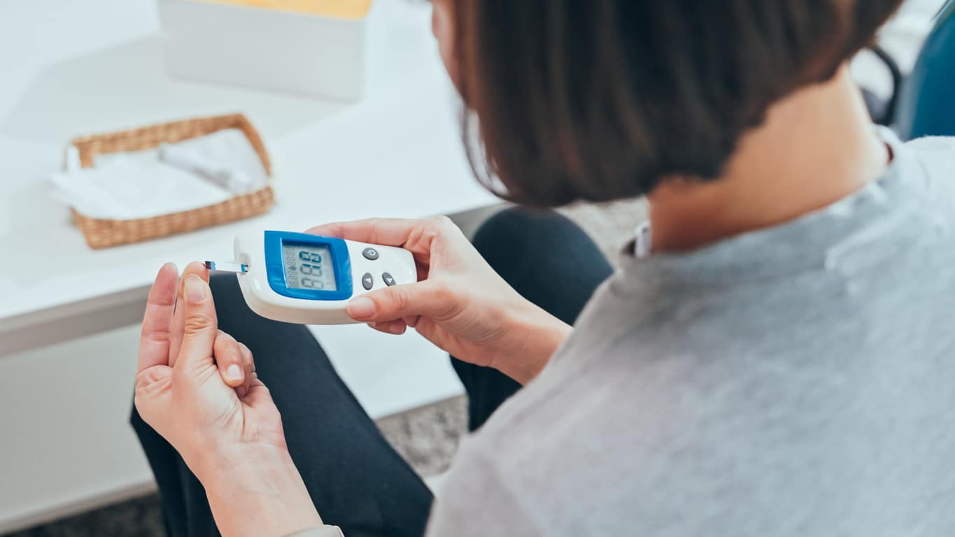 Young adult Woman doing a glucose blood test